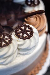 Cake displayed in shop window. Cake with whipped cream. Vanilla cream on top of delicious cake