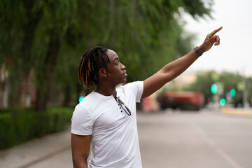 a african american tourist admiring the sights in european city and pointing his finger