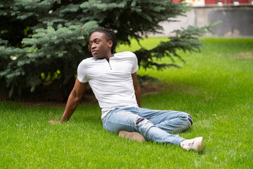 having a rest and chill n the park, young person sitting on the grass
