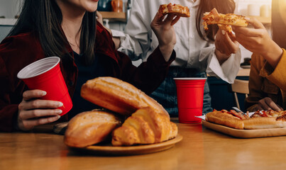 .Friends hangout. Young female celebrating birthday party at weekend at home, eating pizza, drinking champagne, party, lifestyle, friendship