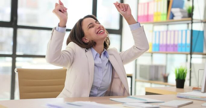 Excited businesswoman feeling euphoric celebrating online success