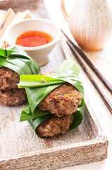 Traditional Thai meatballs with sweet sour chili sauce served as close-up on a design stone tray