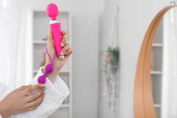 Woman with vibrator and anal plug in bathroom, closeup