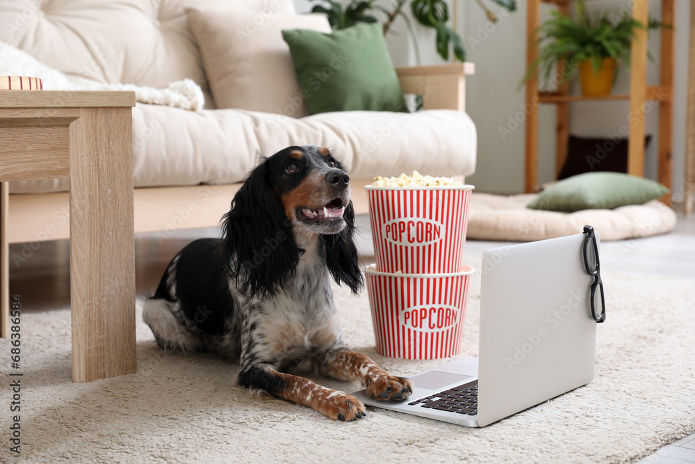 Canvas Prints cute cocker spaniel dog with buckets of popcorn, laptop and 3d cinema glasses lying on carpet in liv