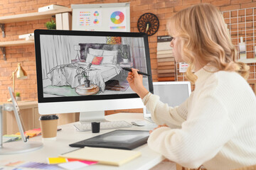 Female interior designer drawing at table in office - obrazy, fototapety, plakaty