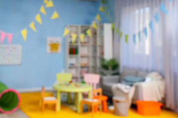 Blurred view of playroom in kindergarten with toys