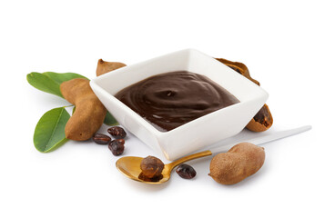 Bowl with tasty tamarind jam and fruits on white background