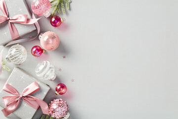 Elegant Christmas background with stylish Xmas decorations, pink balls, gift boxes. Flat lay, top view, copy space.