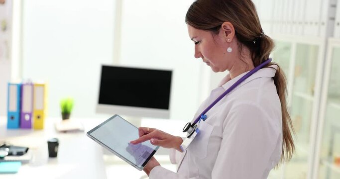 Digital tablet with electrocardiogram in the hands of cardiologist