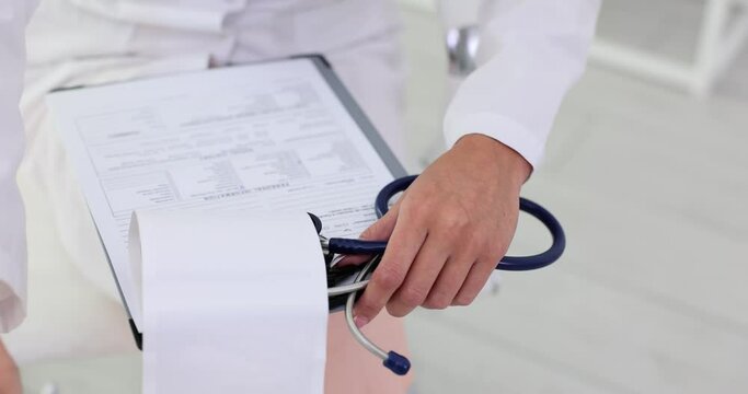 Doctor analyzes results of medical examination of patient in clinic