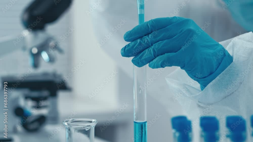 Poster The piped draws the solution into the test tube with a dispenser. Video depicts daily workflow of scientists from different specialties who work together to achieve medical and scientific discoveries.