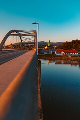 Sunset with a bridge, a church and reflections near Deggendorf, Danube, Bavaria, Germany