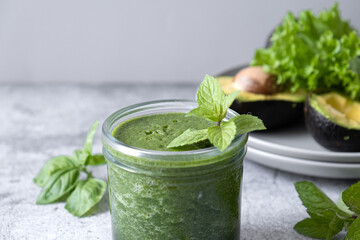Blended green smoothie with ingredients. Healthy smoothie