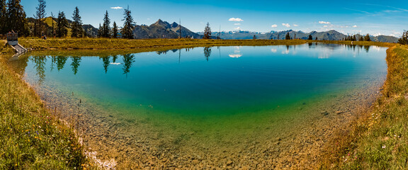 High resolution stitched alpine summer panorama with reflections at Lake Spiegelsee, Mount Fulseck,...