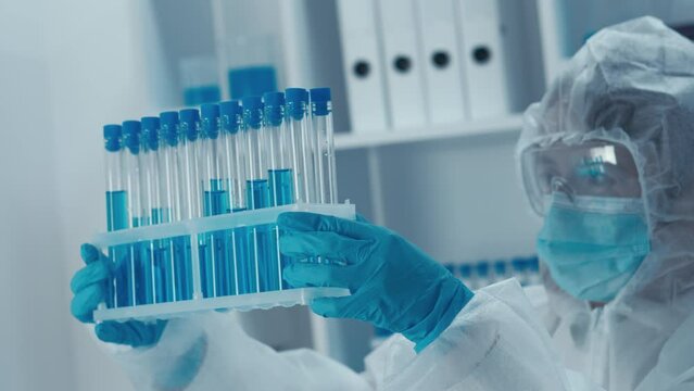 The video emphasizes women's participation in biotech research and drug development. She works in a laboratory using cutting-edge technology to produce medical innovations.