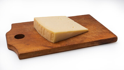 slice of Asiago cheese on wooden cutting board. isolated white background