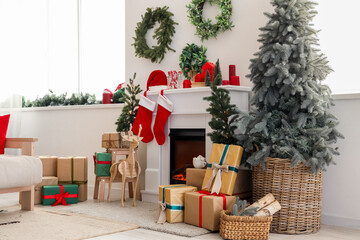 Interior of festive living room with fireplace, gift boxes, Christmas tree and decorations