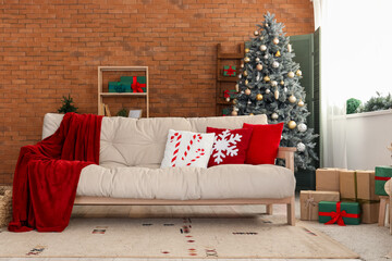 Interior of festive living room with cozy white sofa and Christmas decorations