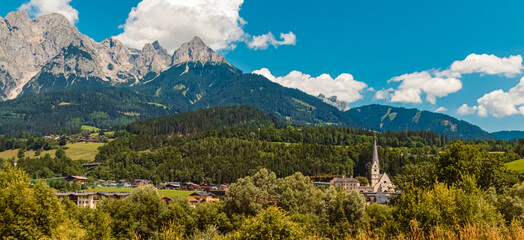 Alpine summer view with a church and the Tennengebirge mountains near Pfarrwerfen, St. Johann im...
