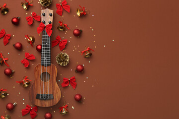 Composition with ukulele and beautiful Christmas decorations on color background