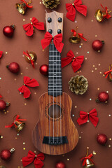 Composition with ukulele and beautiful Christmas decorations on color background