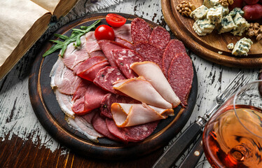 Antipasto cold meat platter with sausage, ham, salami,  parma, prosciutto, bacon decorated with...