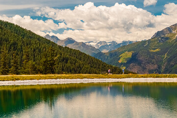 Alpine summer view with reflections in a lake at Serles cable car station, Mieders, Stubaital valley, Innsbruck, Austria