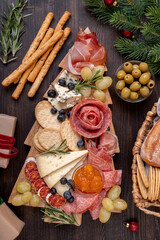 Charcuterie board italian food antipasti prosciutto ham, salami and cheese appetizers served in the...