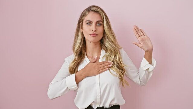 Proud young blonde woman in shirt, standing over pink isolate background, swears heartfelt loyalty oath, hand on chest, trust in her palm.