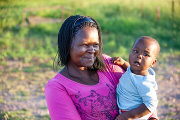 village african mother with braids carry child in her arms