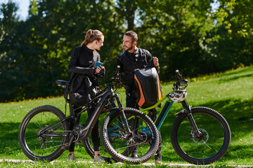 Fototapeta premium A sweet couple, equipped with bicycles and engrossed in coordinating their journey, checks their GPS mobile and watches while planning scenic routes in the park, seamlessly blending technology and