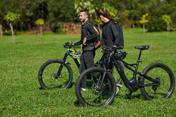 Fototapeta premium A blissful couple, adorned in professional cycling gear, enjoys a romantic bicycle ride through a park, surrounded by modern natural attractions, radiating love and happiness