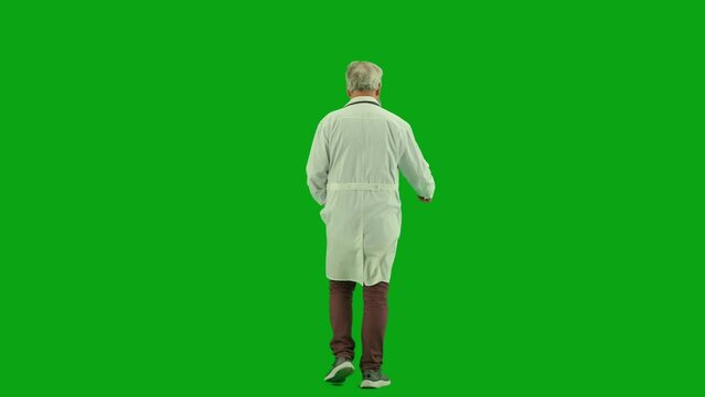 Portrait of aged man medic on chroma key green screen. Back view senior doctor in uniform walking in hospital corridor and talking with nurse.