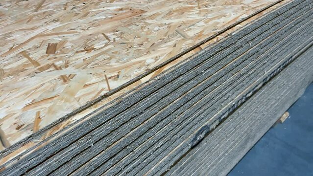 Sheets chipboards stacked in the warehouse of a woodworking factory or hardware store