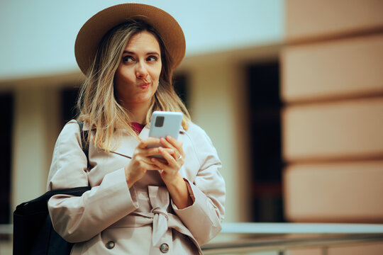 Funny Woman Making Silly Facial Expressions and Texting. Girl reacting to a wired text she received 
 - Powered by Adobe