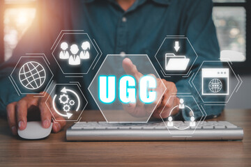 UGC, User generated content concept, Businessman using comuter on office desk with User generated content icon on virtual screen.