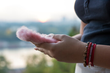 Close up view of female hands using smartphone near the river during sunset