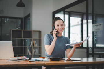 Business woman using business paper for doing math finance on office desk, tax, report, accounting, statistics, and analytical research concept