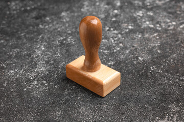 One wooden stamp tool on dark textured table