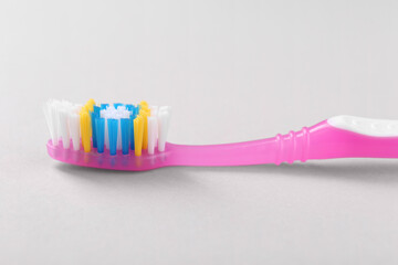One plastic toothbrush on light background, closeup
