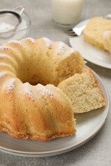 Delicious freshly baked sponge cake on gray table, closeup
