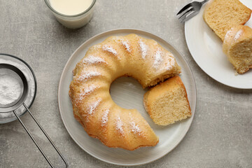 Delicious sponge cake served on gray table, flat lay