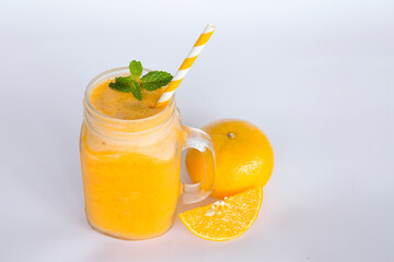 Orange smoothies yellow colorful fruit juice milkshake blend beverage healthy high protein the taste yummy In glass,drink to lose weight drink episode morning on white gray background.