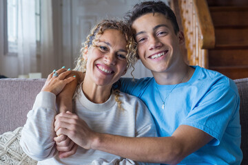 Portrait of grateful teenager man hug smiling middle-aged mother show love and care, thankful happy...