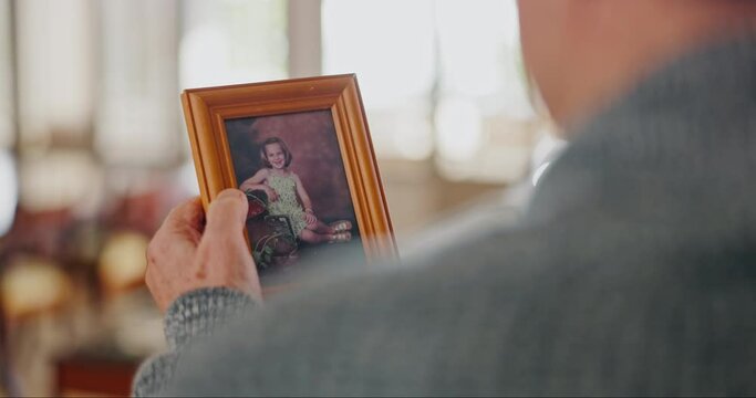 Photograph, senior person and hands for memory or nostalgia, grief and love for child in retirement. Elderly man, frame and touch a picture to remember life, vintage and retro image of history