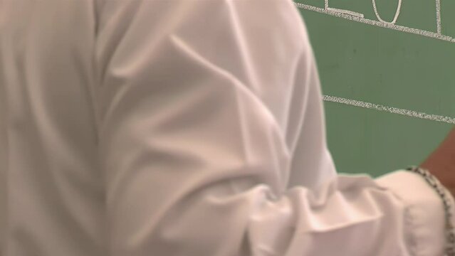 Public School Teacher Writing on Chalkboard at a Public Primary School in Argentina. Close Up. 4K Resolution.