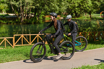 Obraz premium A blissful couple, adorned in professional cycling gear, enjoys a romantic bicycle ride through a park, surrounded by modern natural attractions, radiating love and happiness