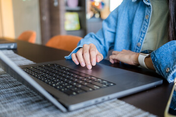 Hand type on the notebook computer in office