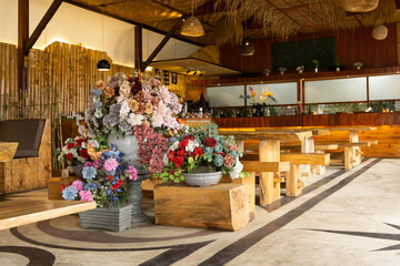 Flowers decoration in food court interior. Asian restaurant with warm light