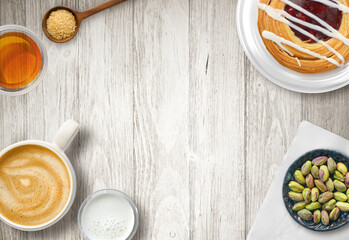 Cafe Latte or coffee with cream and pastry on table top